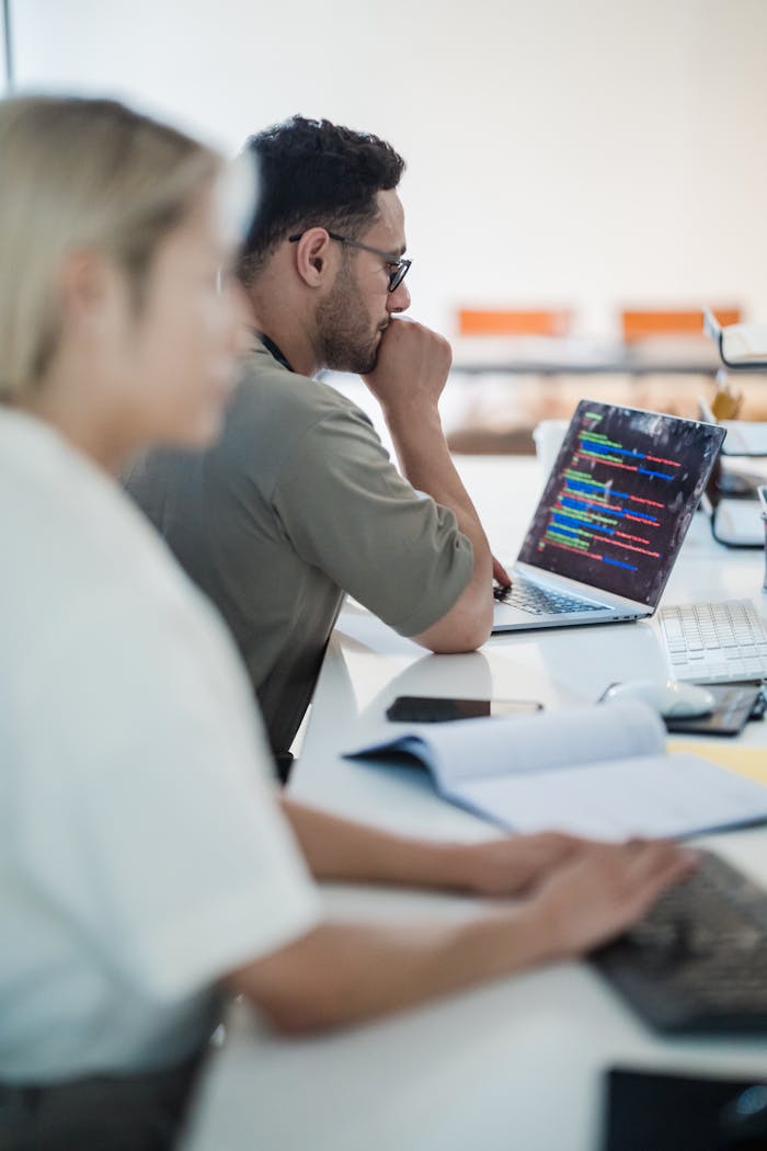 Mastering the First Impression: Your intriguing post title goes here Two software developers work collaboratively on a coding project in a modern office setting.